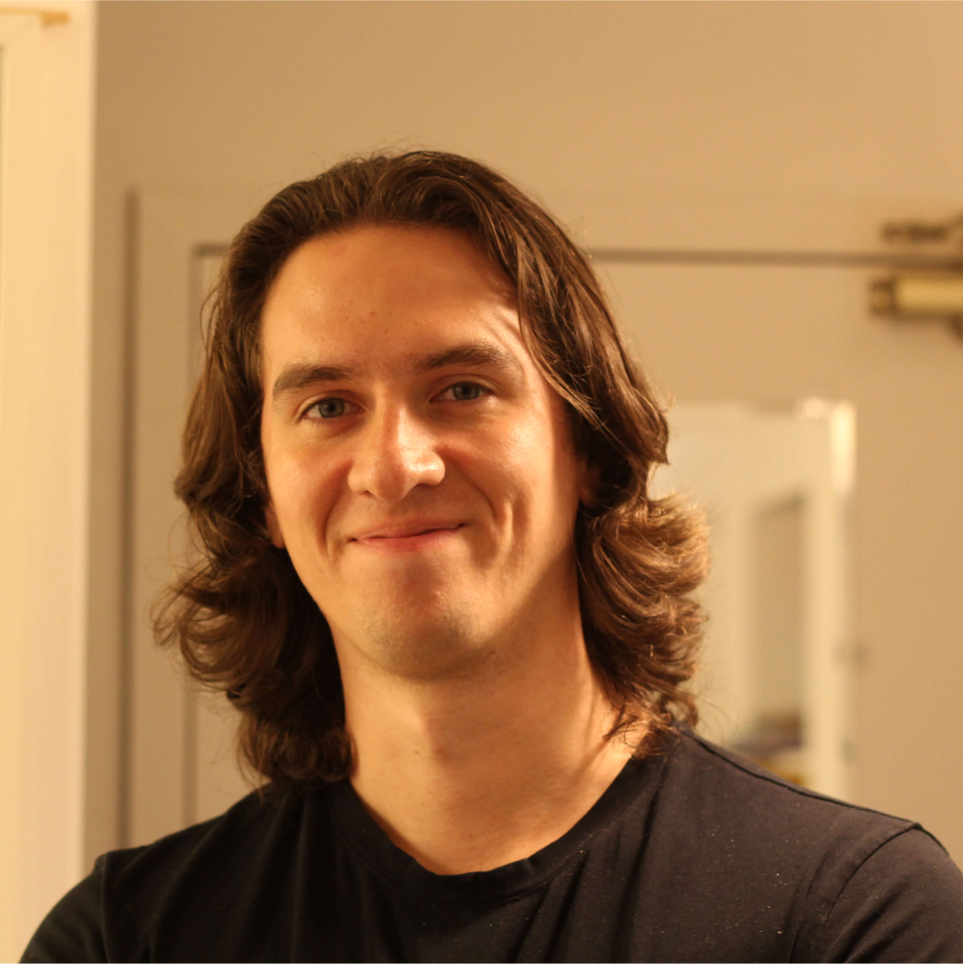 A headshot of Jeridan Kowal with long hair.