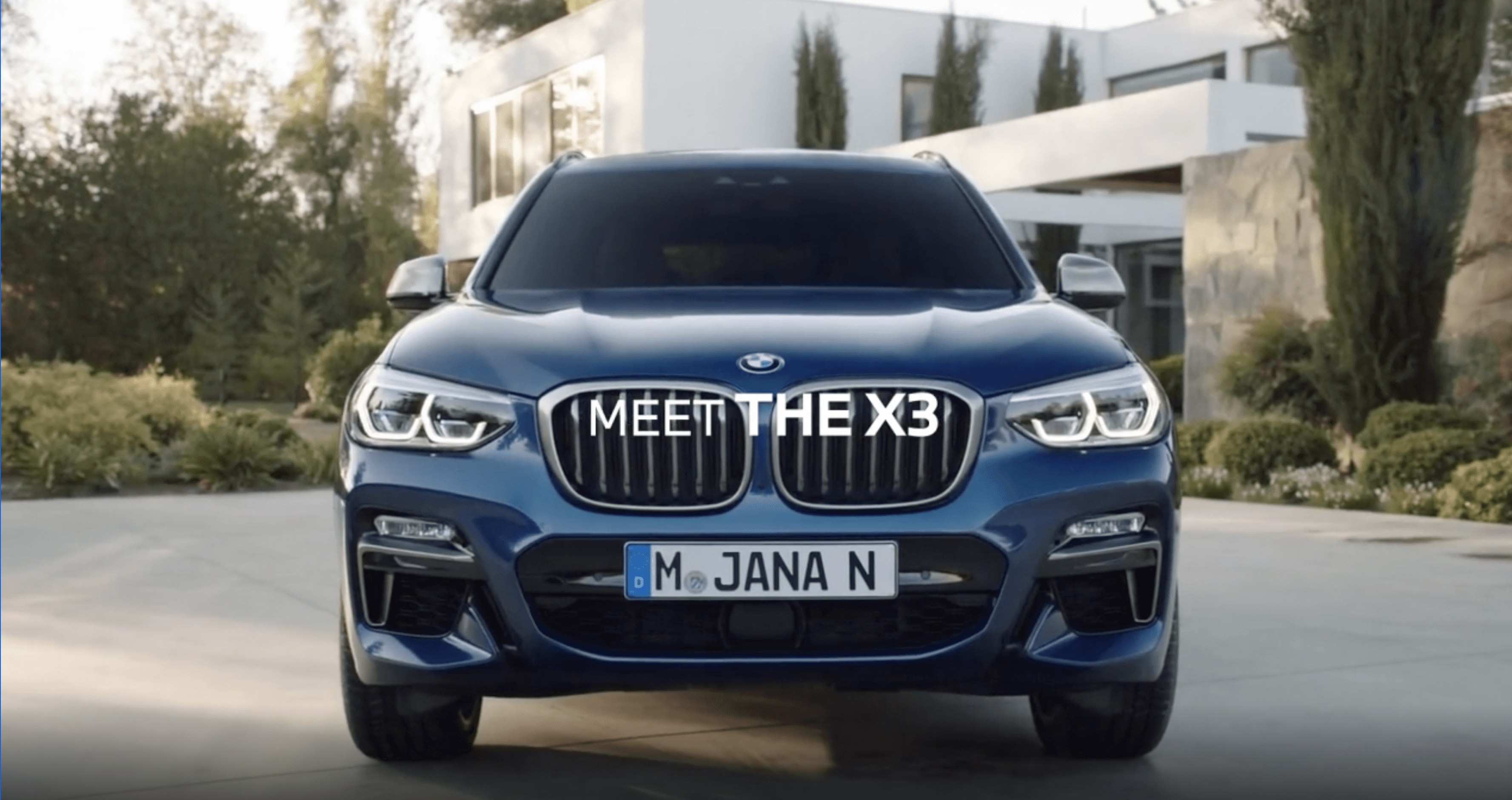 The front of a large dark blue BMW.